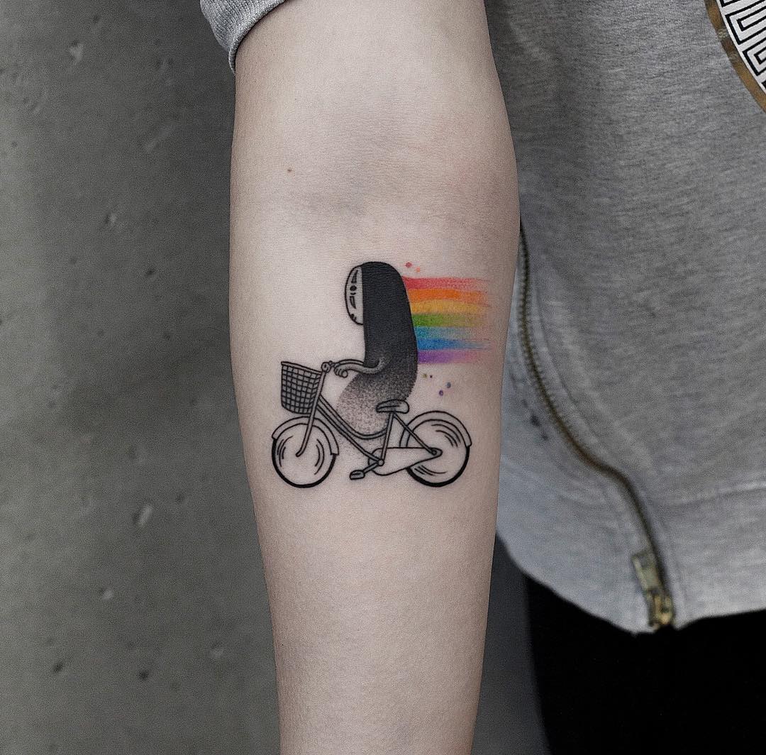 Whimsical Rainbow Tattoo of a Biking Figure