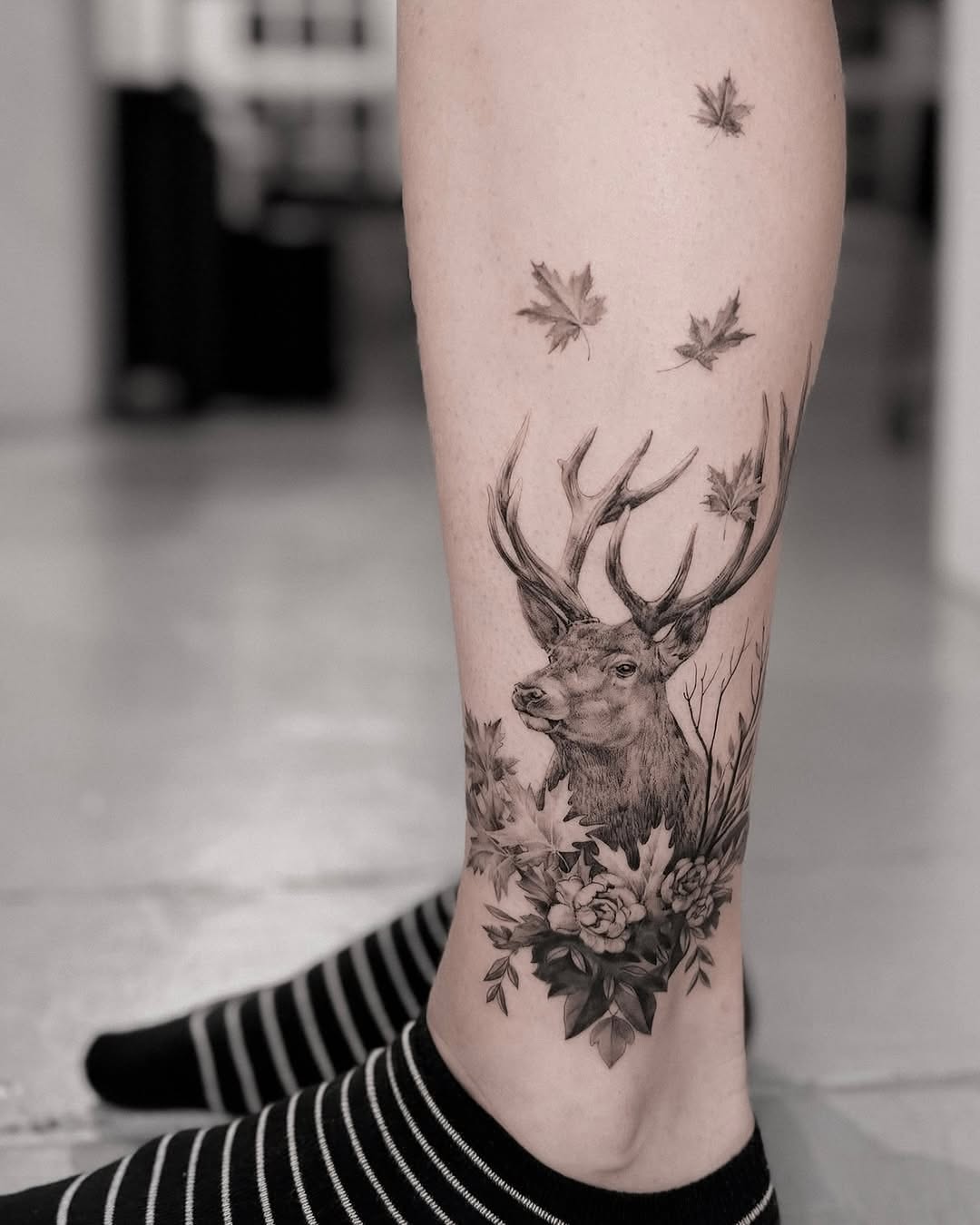 Elegant realistic deer tattoo with floral elements