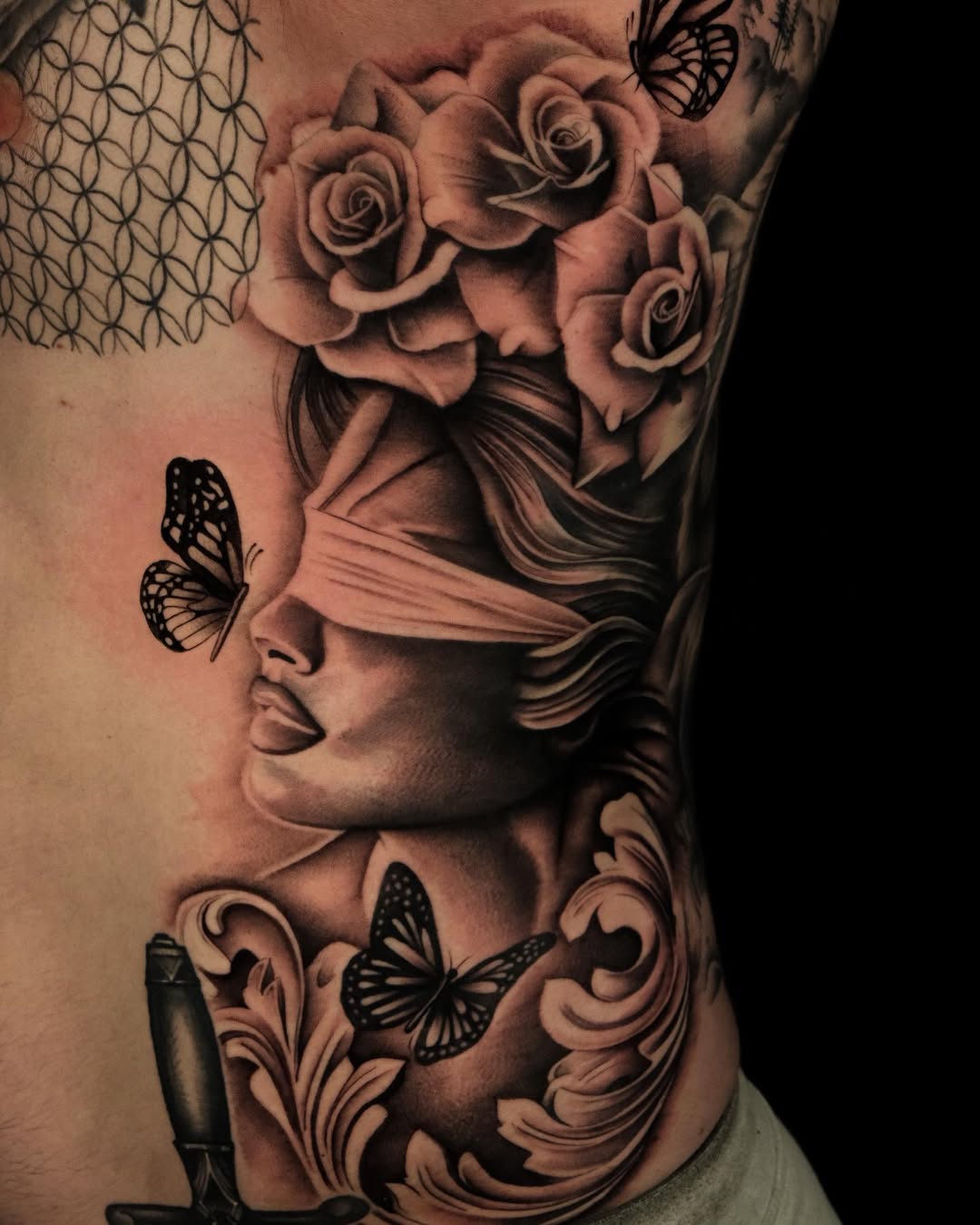 Elegant Rib Tattoo Featuring Roses and Butterflies