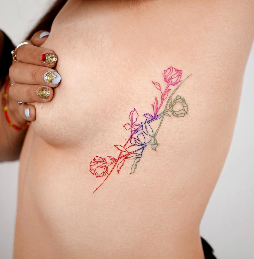 Stunning Rib Tattoo Featuring Colorful Flowers