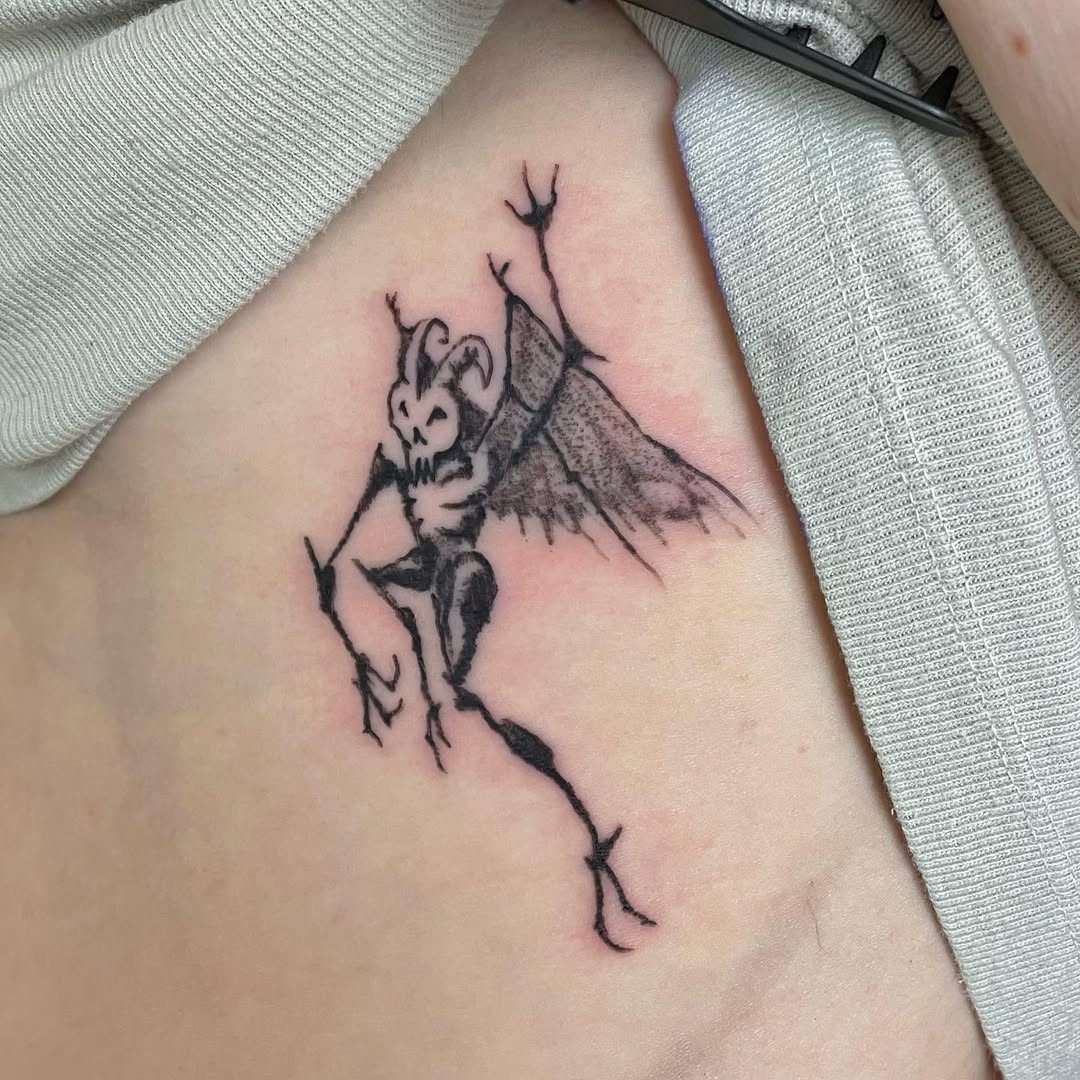 Unique Rib Tattoo Design Featuring a Demon