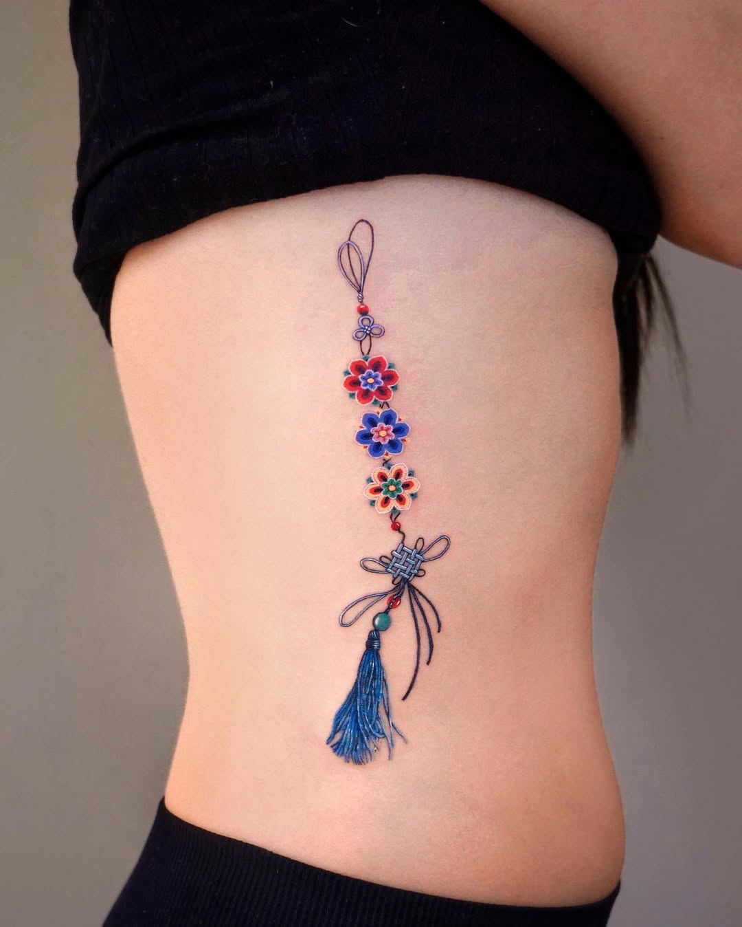 Beautiful Rib Tattoo With Floral Motifs