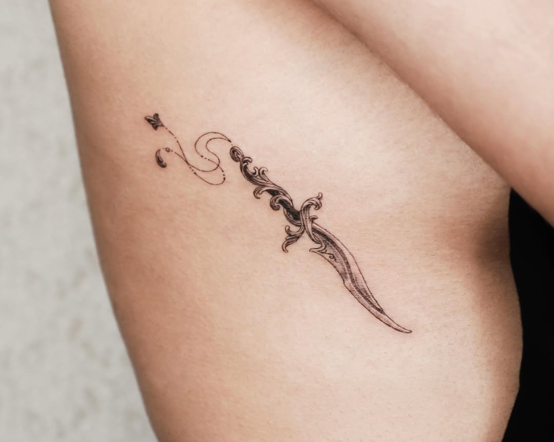 Elegant Rib Tattoo with Floral Knife Design