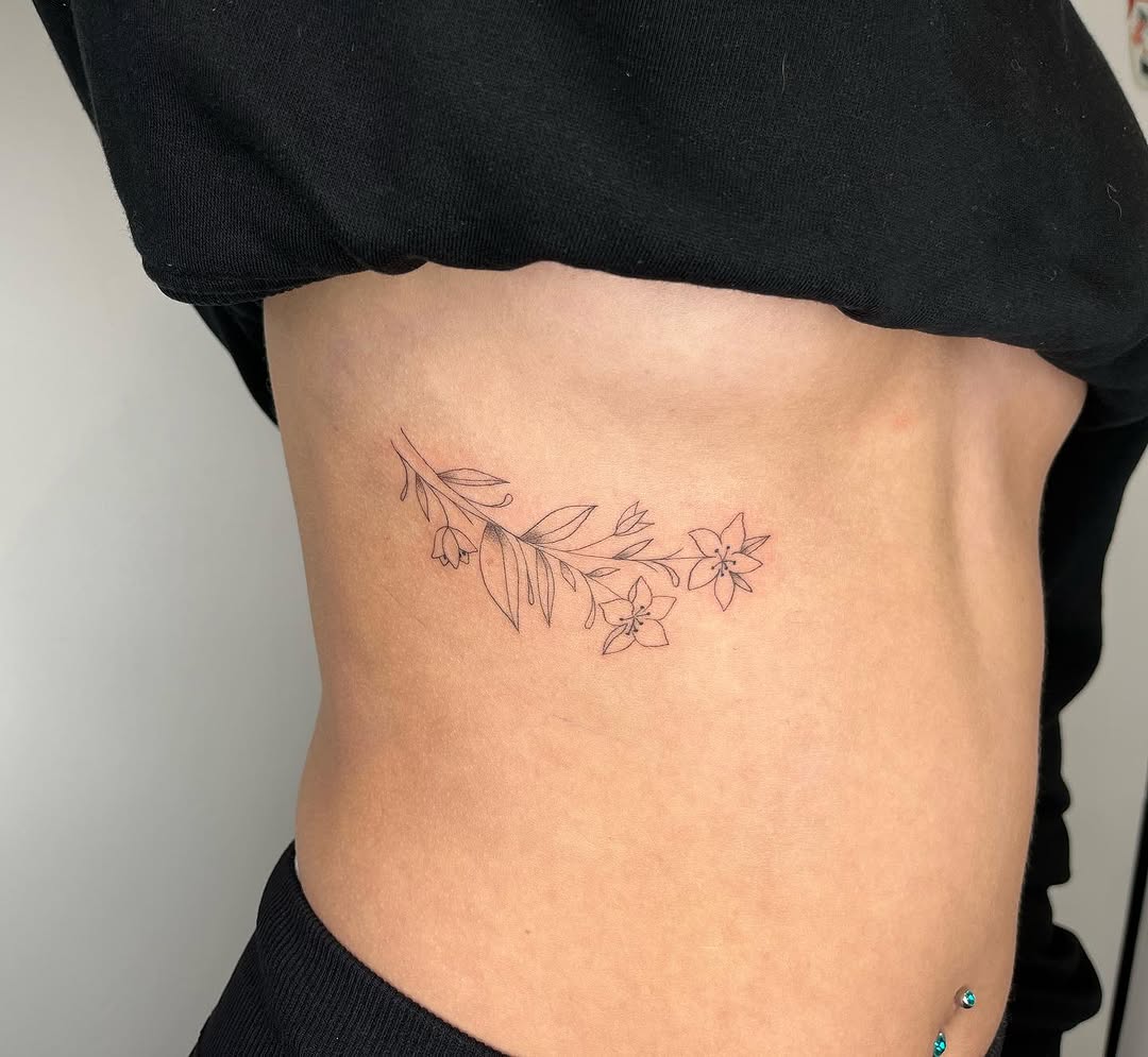 Elegant Floral Rib Tattoo: A Delicate Design