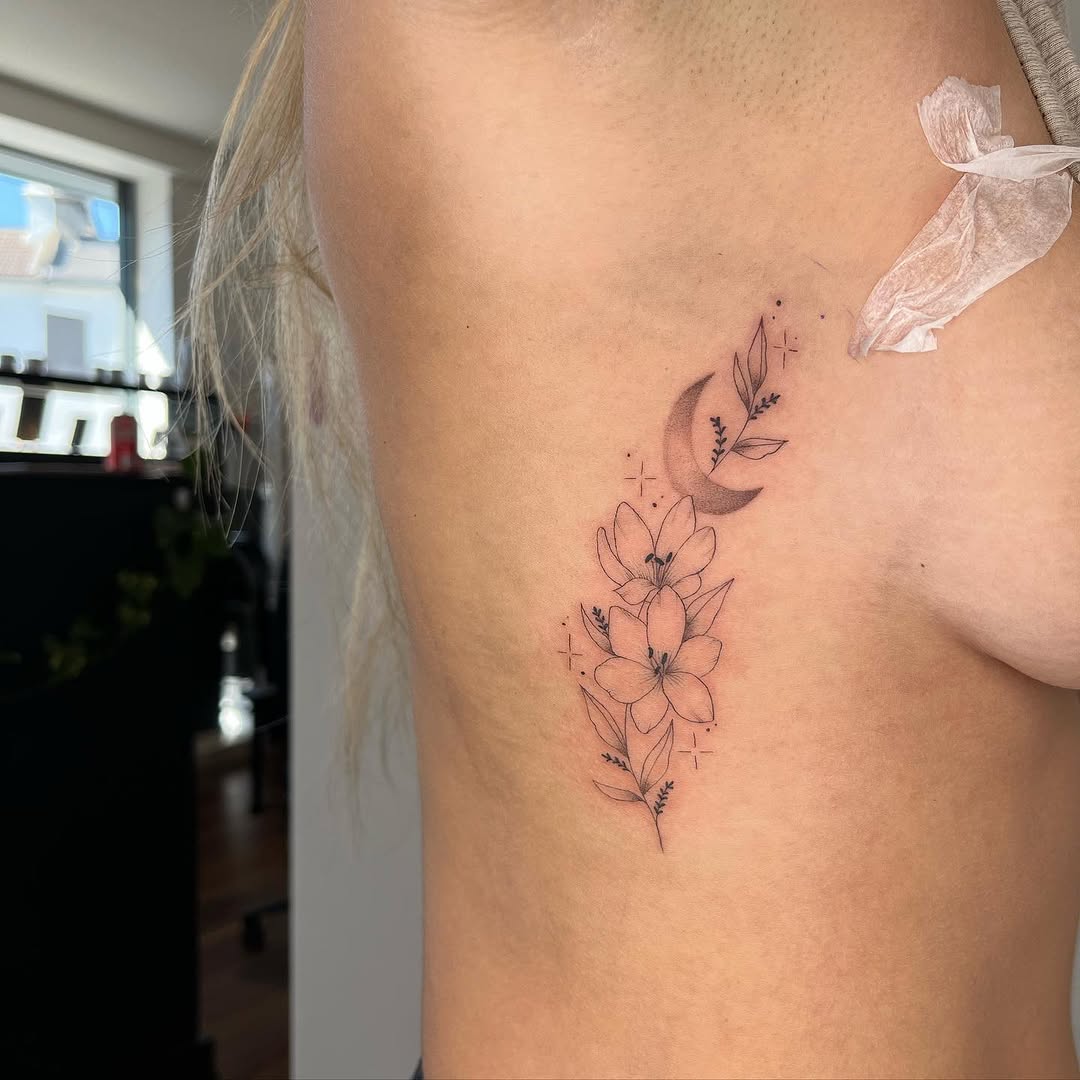 Elegant Rib Tattoo Featuring Moon and Flowers