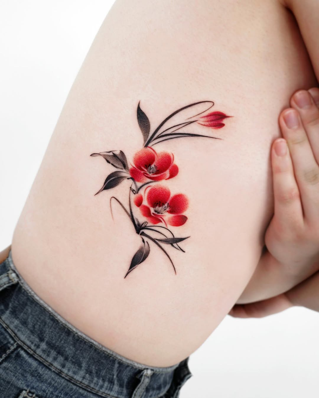 Beautiful Rib Tattoo Design with Red Flowers