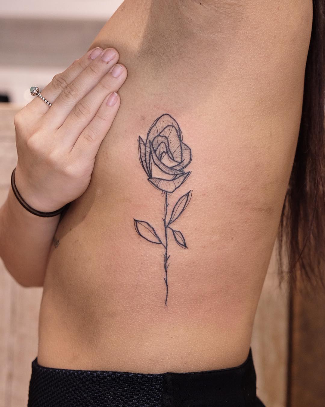 Stunning Rib Tattoo of a Delicate Rose