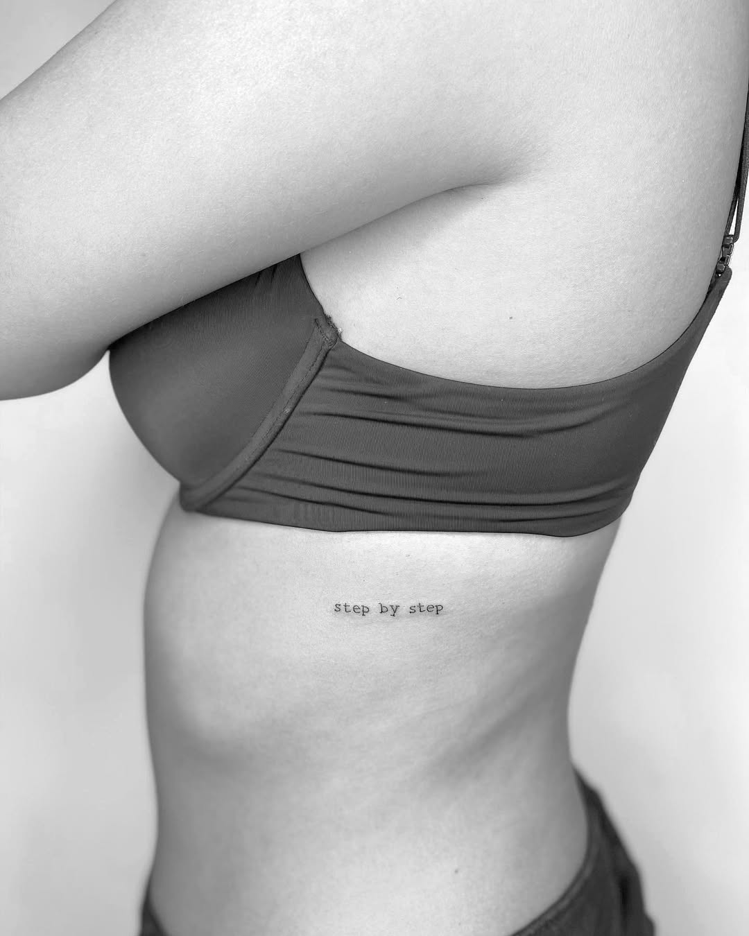 Elegant Rib Tattoo with Meaningful Phrase