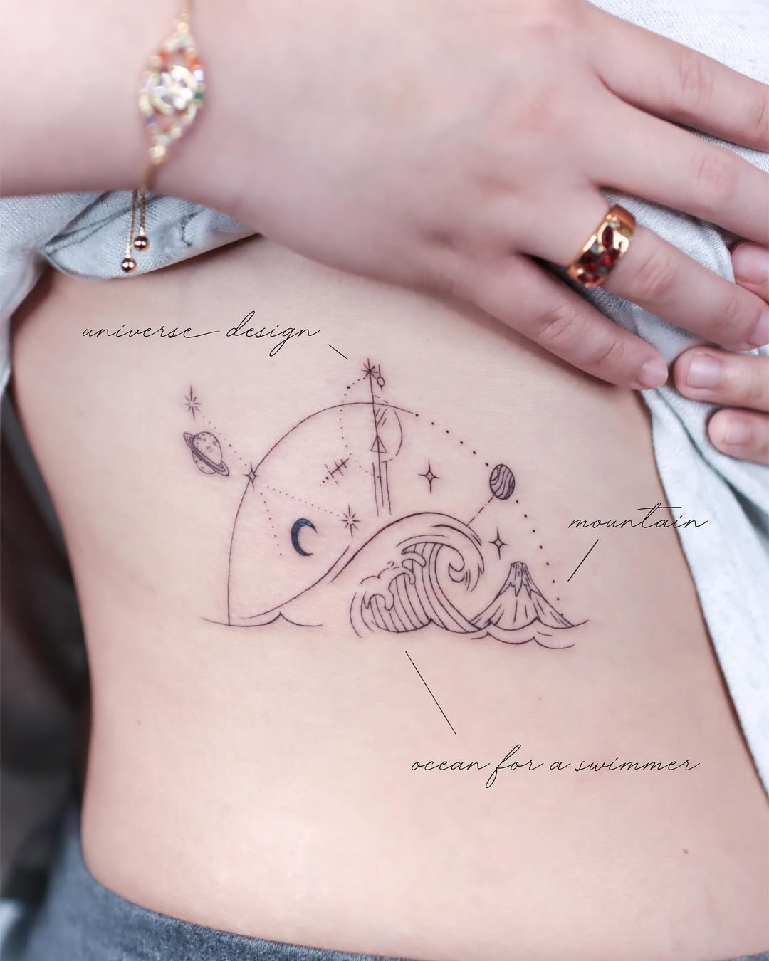 Elegant Rib Tattoo with Cosmic Elements