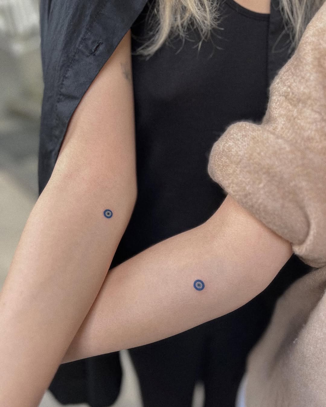 Minimalistic blue circle tattoos for sisters