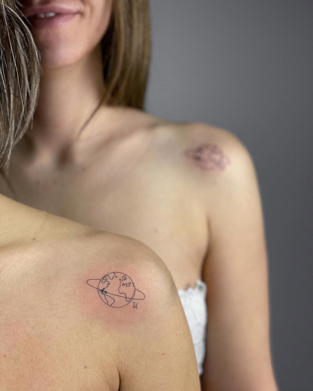 Delicate sister tattoos symbolizing global connection