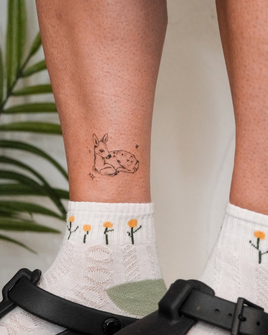 Charming small deer tattoo on ankle.