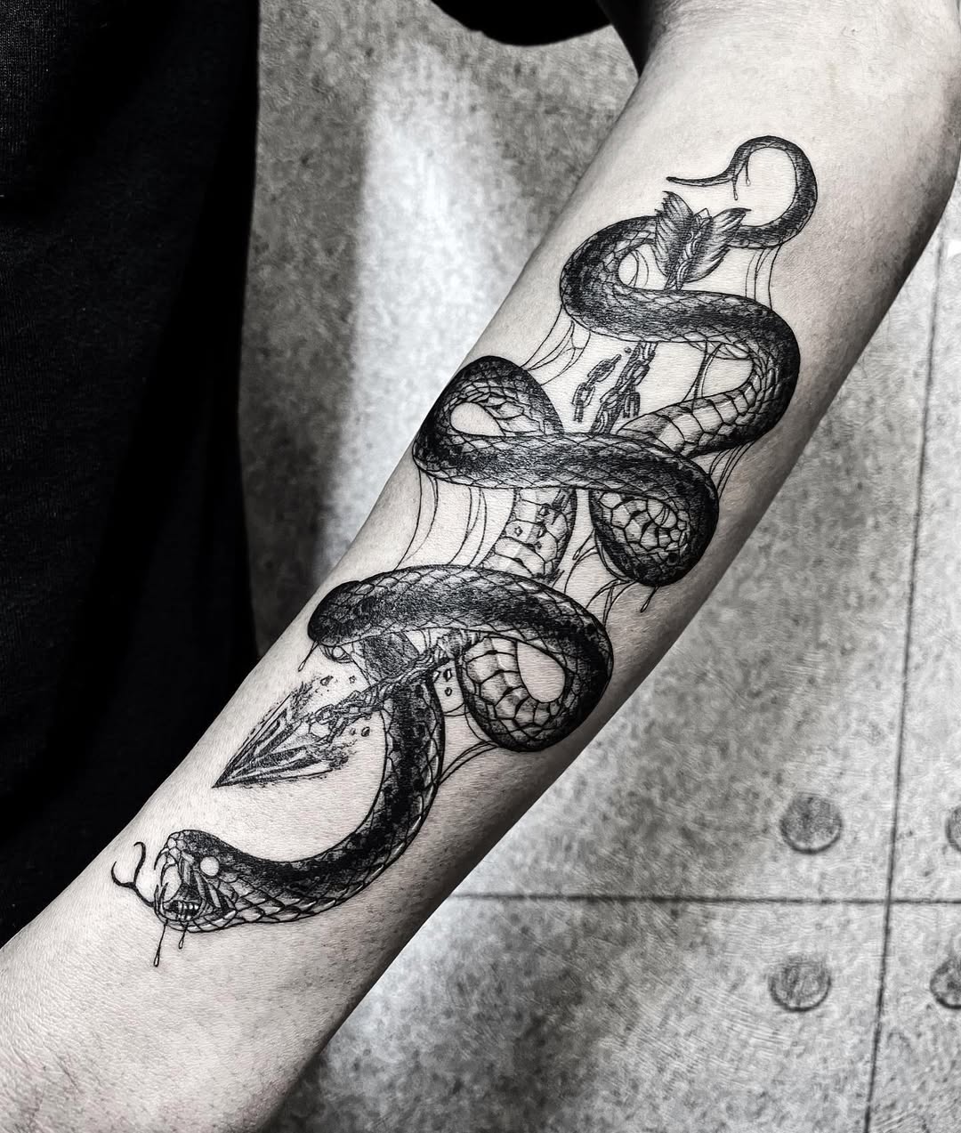 Intricate snake and arrow tattoo design