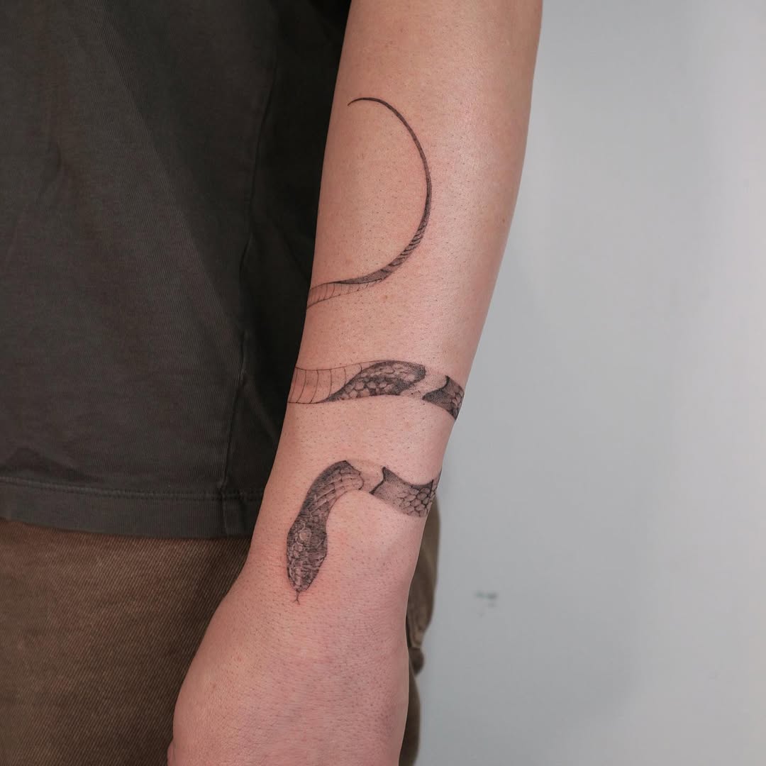 Elegant snake bracelet tattoo design on forearm