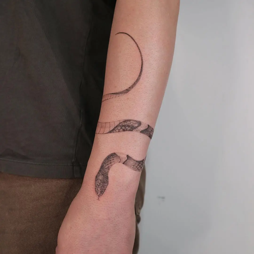 Elegant snake bracelet tattoo design on forearm