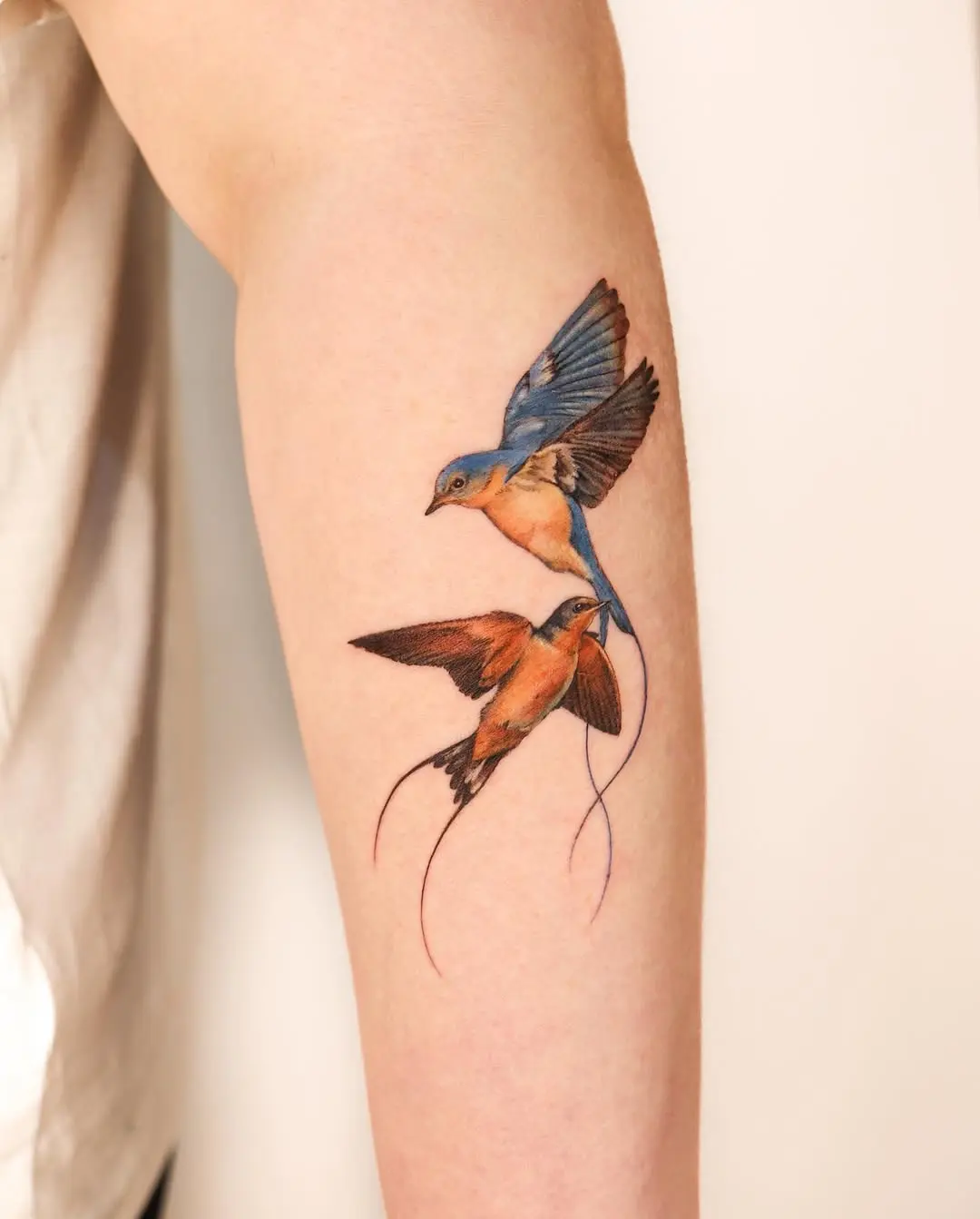 Stunning pair of vibrantly colored birds tattoo