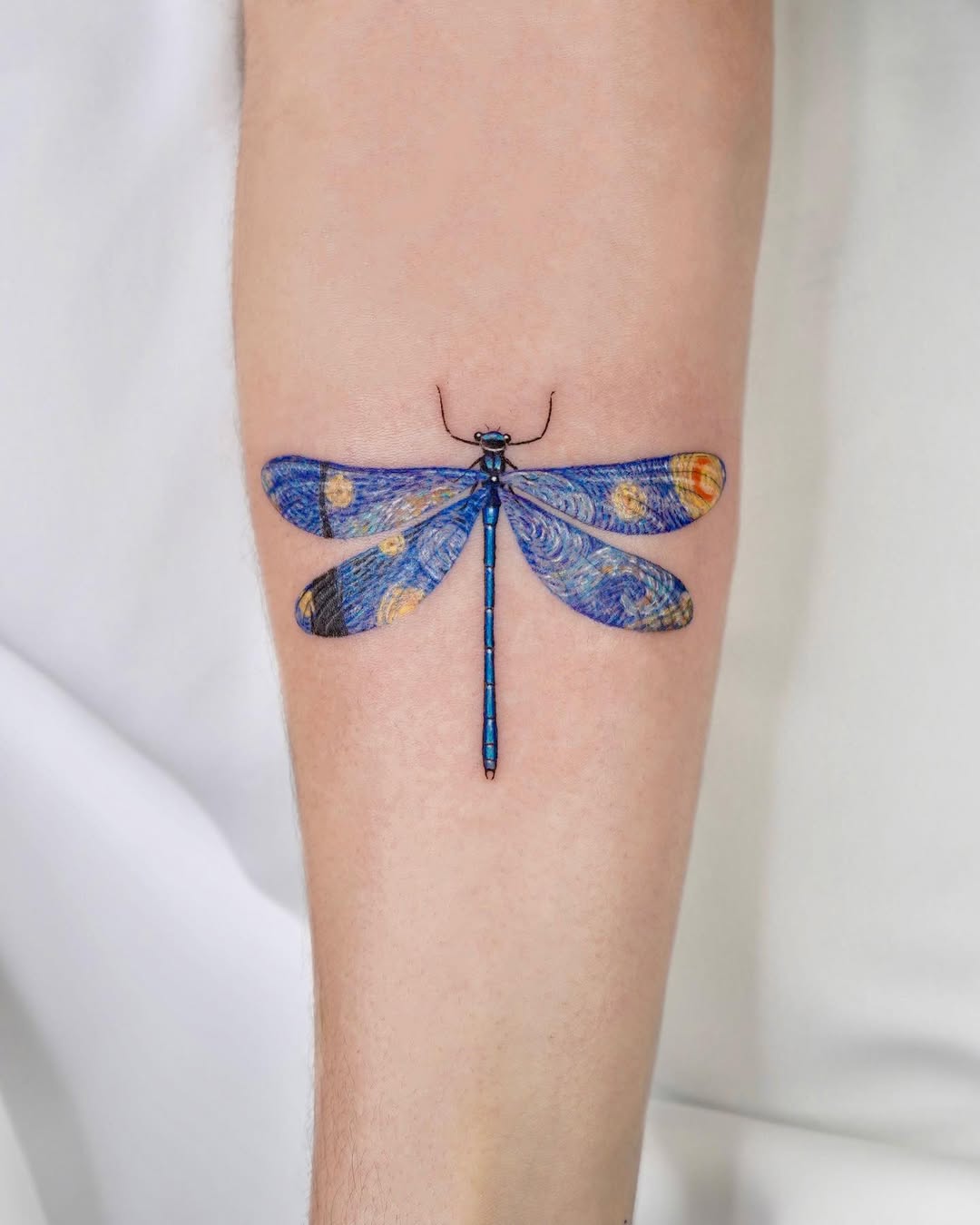 Stunning artistic dragonfly tattoo on arm