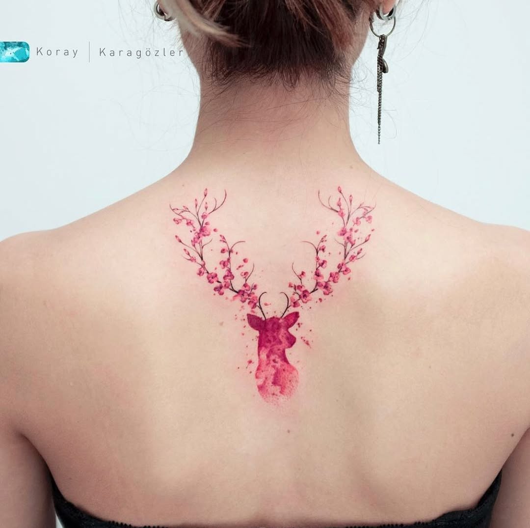 Vibrant watercolor deer tattoo with floral antlers