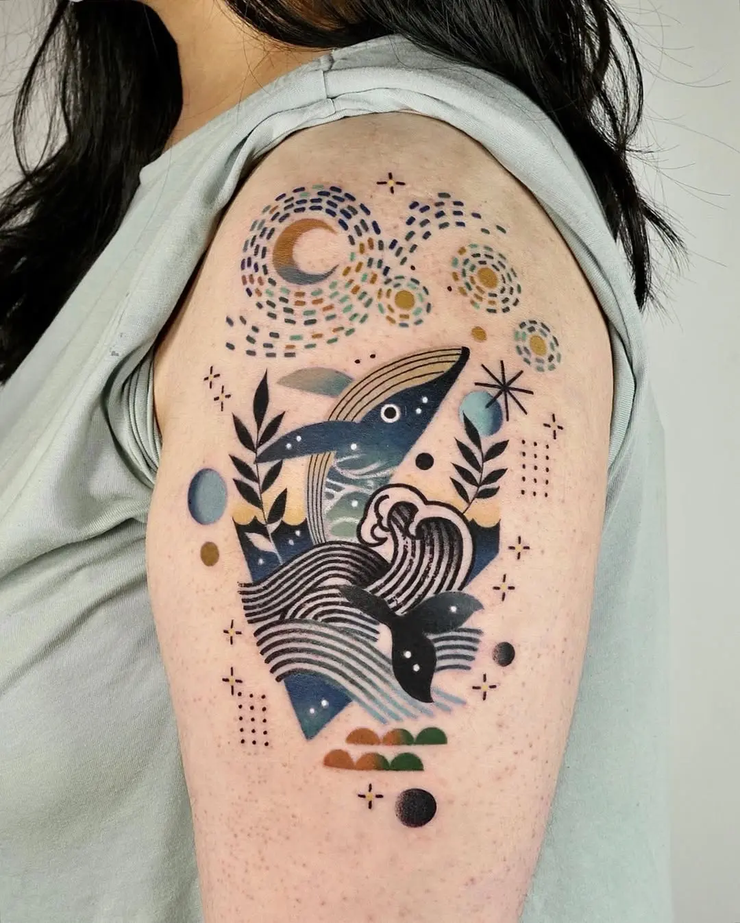 Colorful whale tattoo with cosmic elements