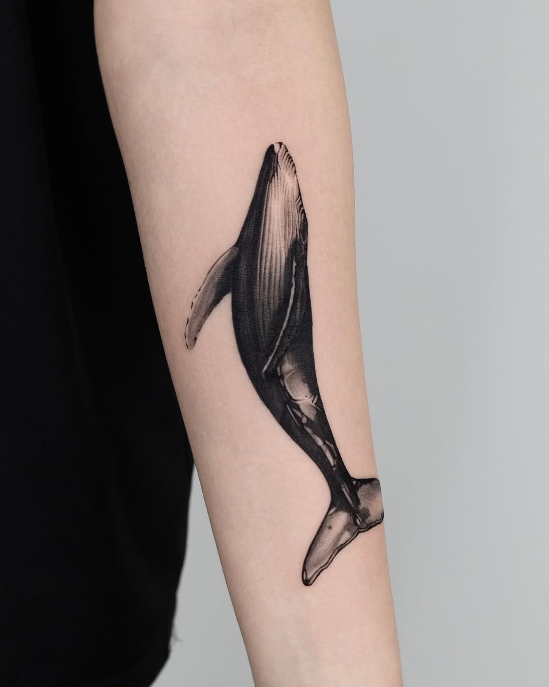 Stunning detailed whale tattoo on forearm