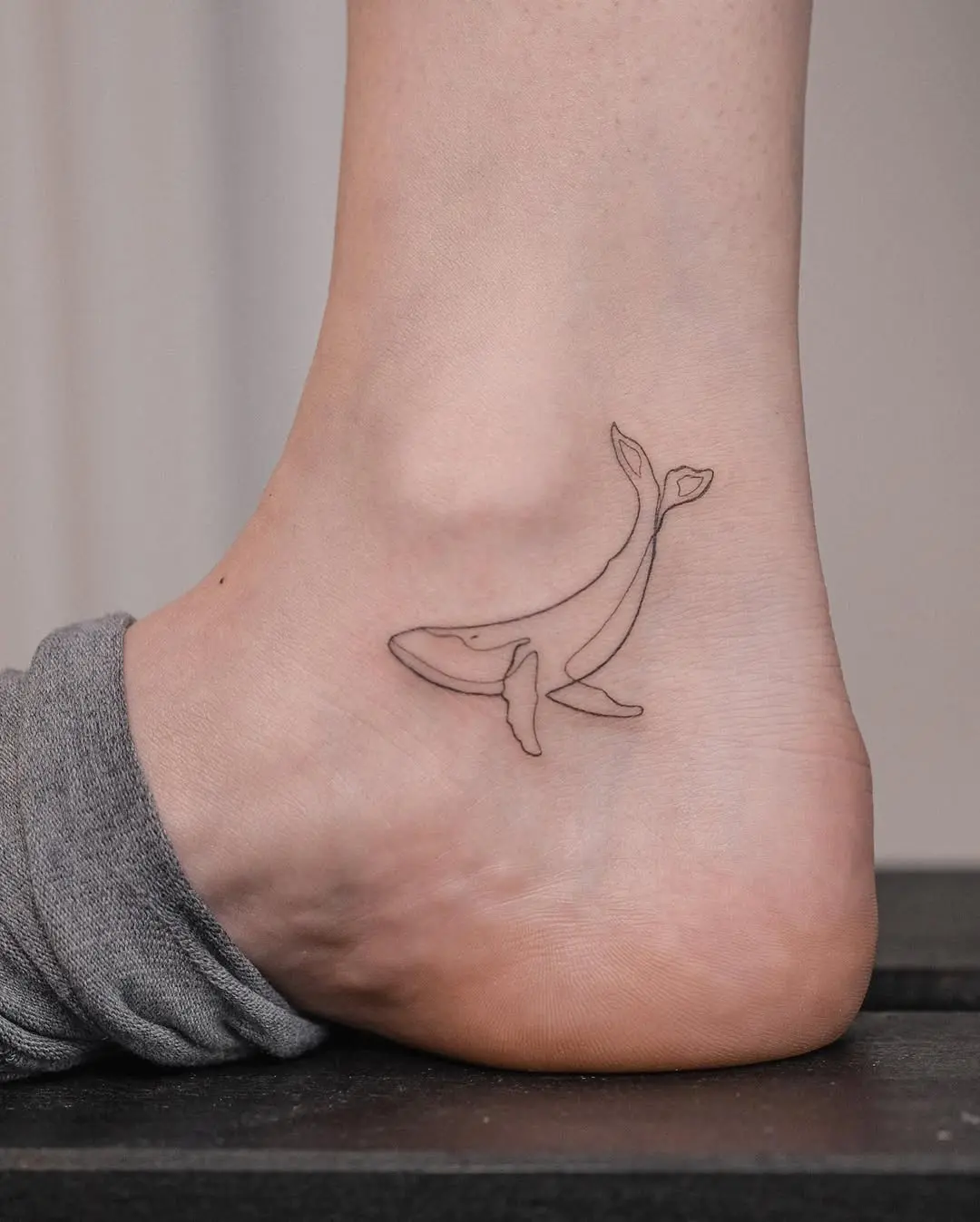 Charming Minimalist Whale Tattoo on the Ankle
