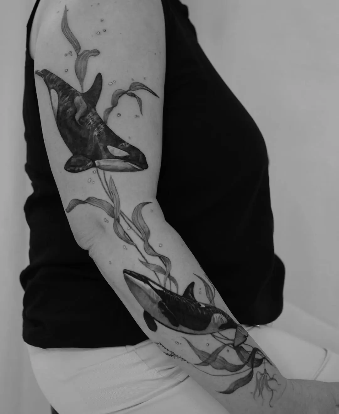 Stunning minimalist whale tattoo on the arm