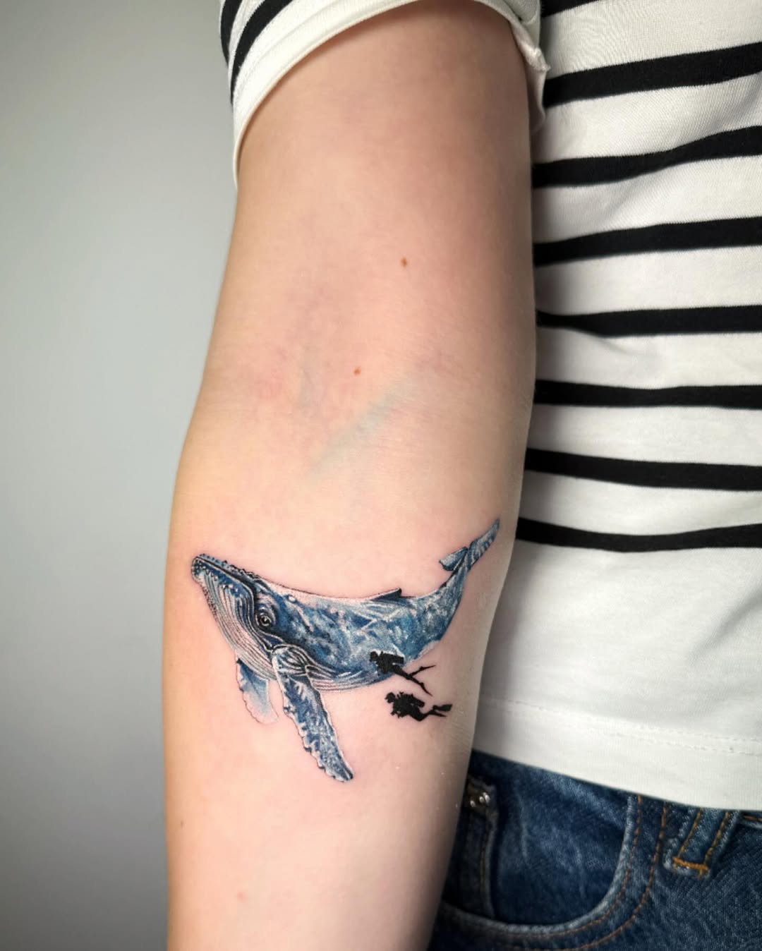 Elegant whale tattoo design on the arm