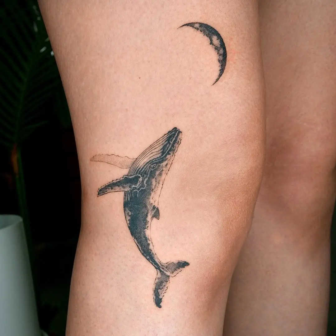 Elegant whale tattoo with a crescent moon