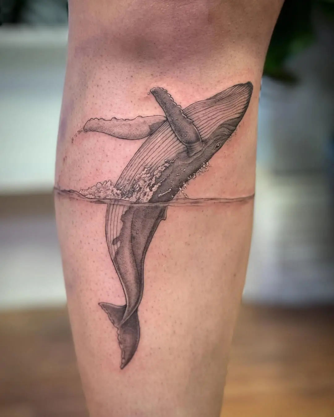 Whale tattoo with water splash detail