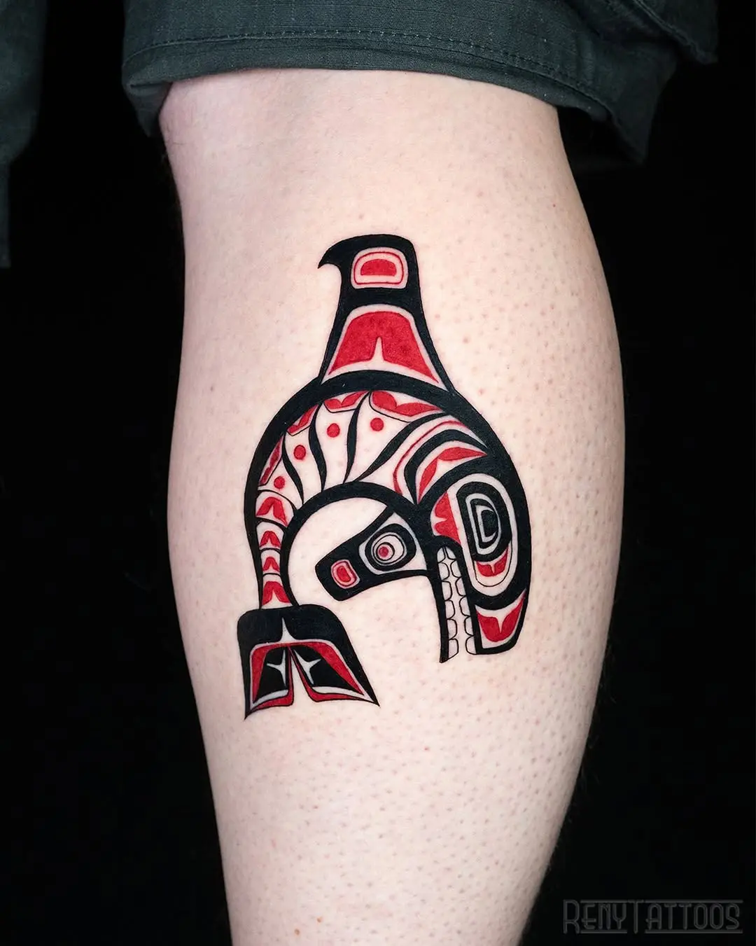 Striking tribal whale tattoo with bold colors