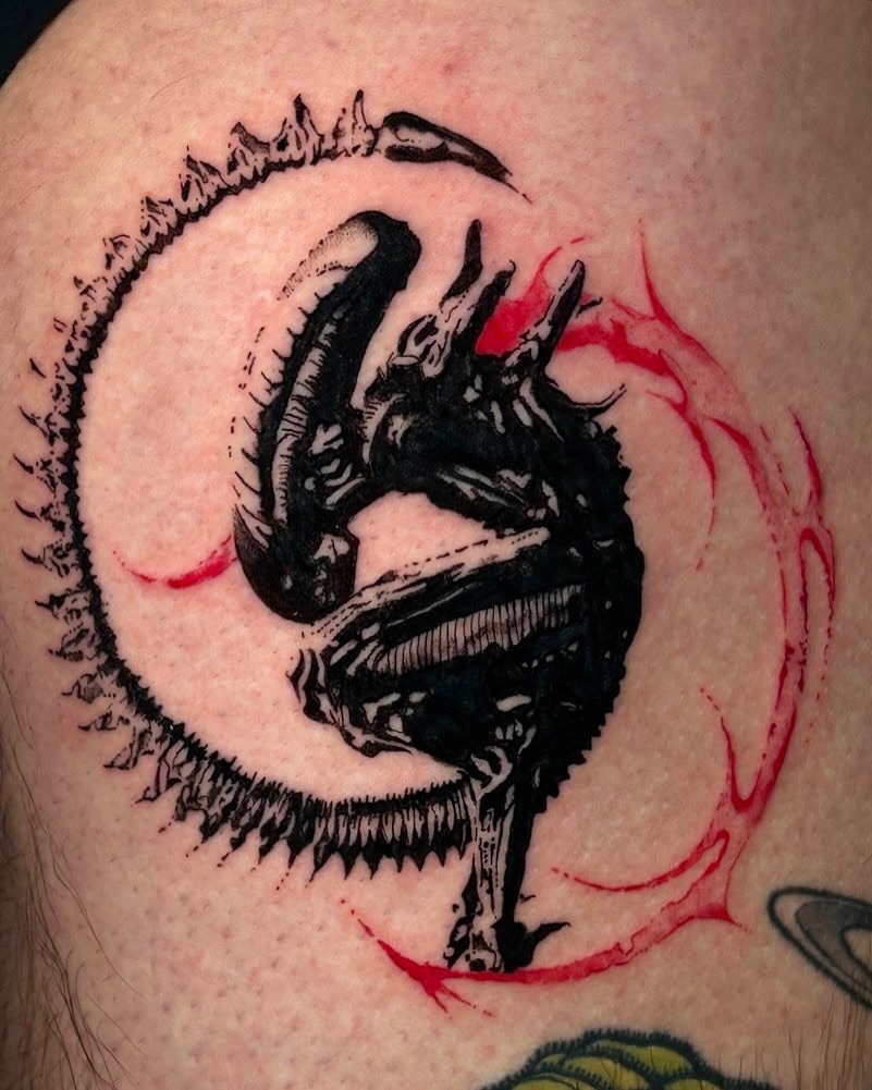 Intricate alien tattoo with vibrant red accents