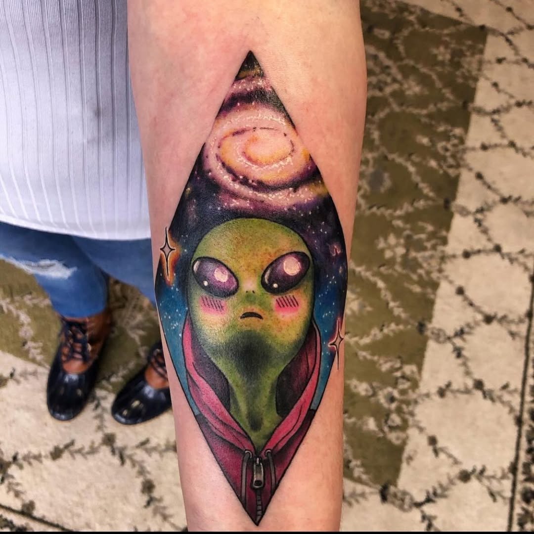 Vibrant Alien Tattoo with Cosmic Elements