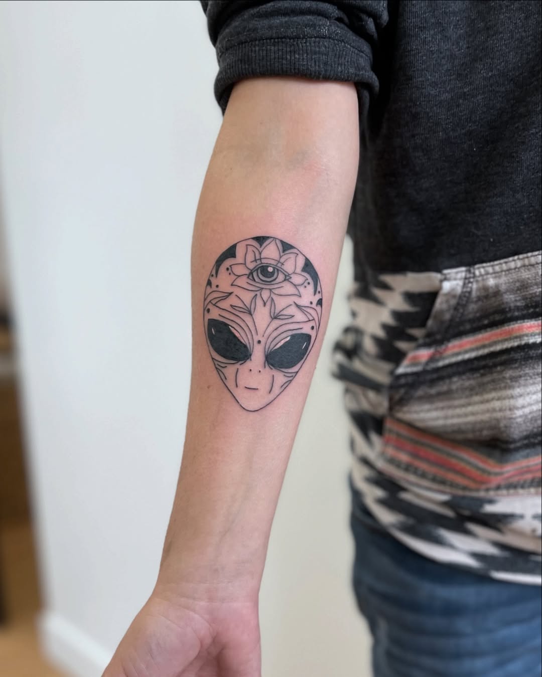 Unique alien tattoo with a spiritual touch