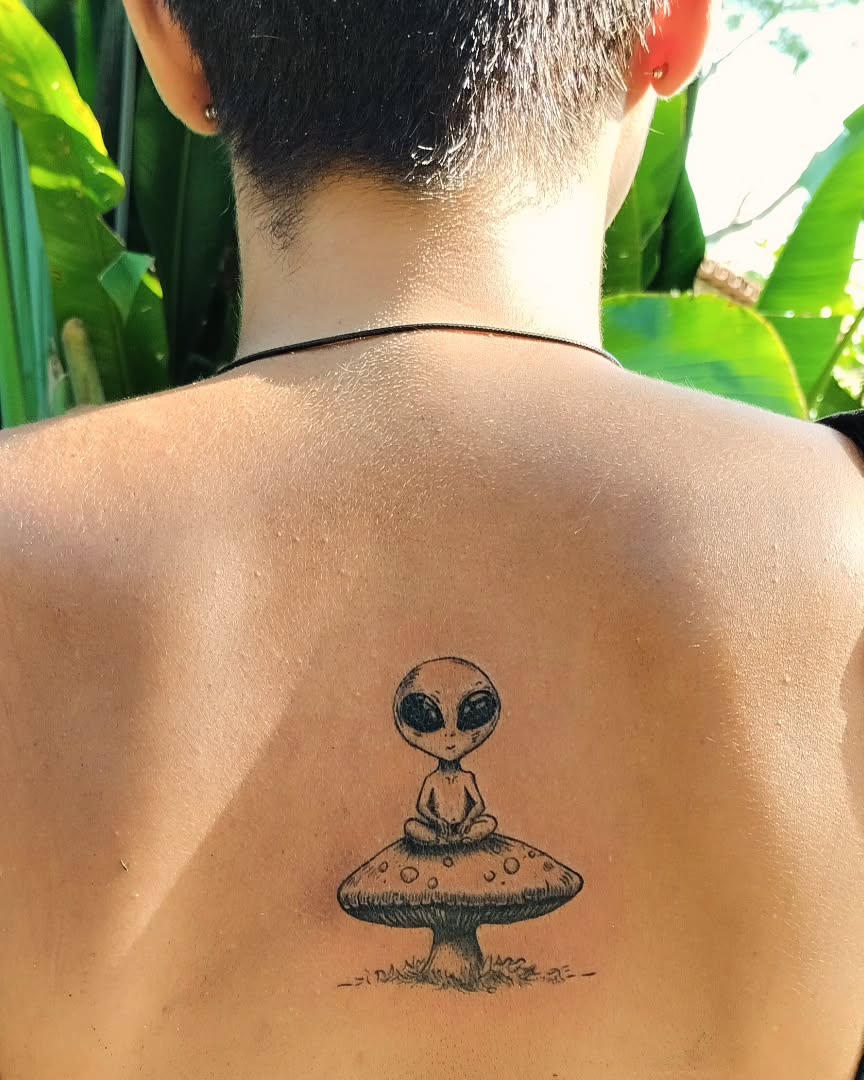 Intriguing alien tattoo on a mushroom backdrop