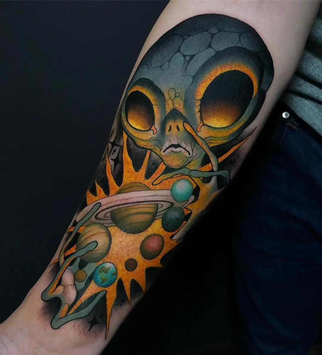 Vibrant alien tattoo with cosmic elements