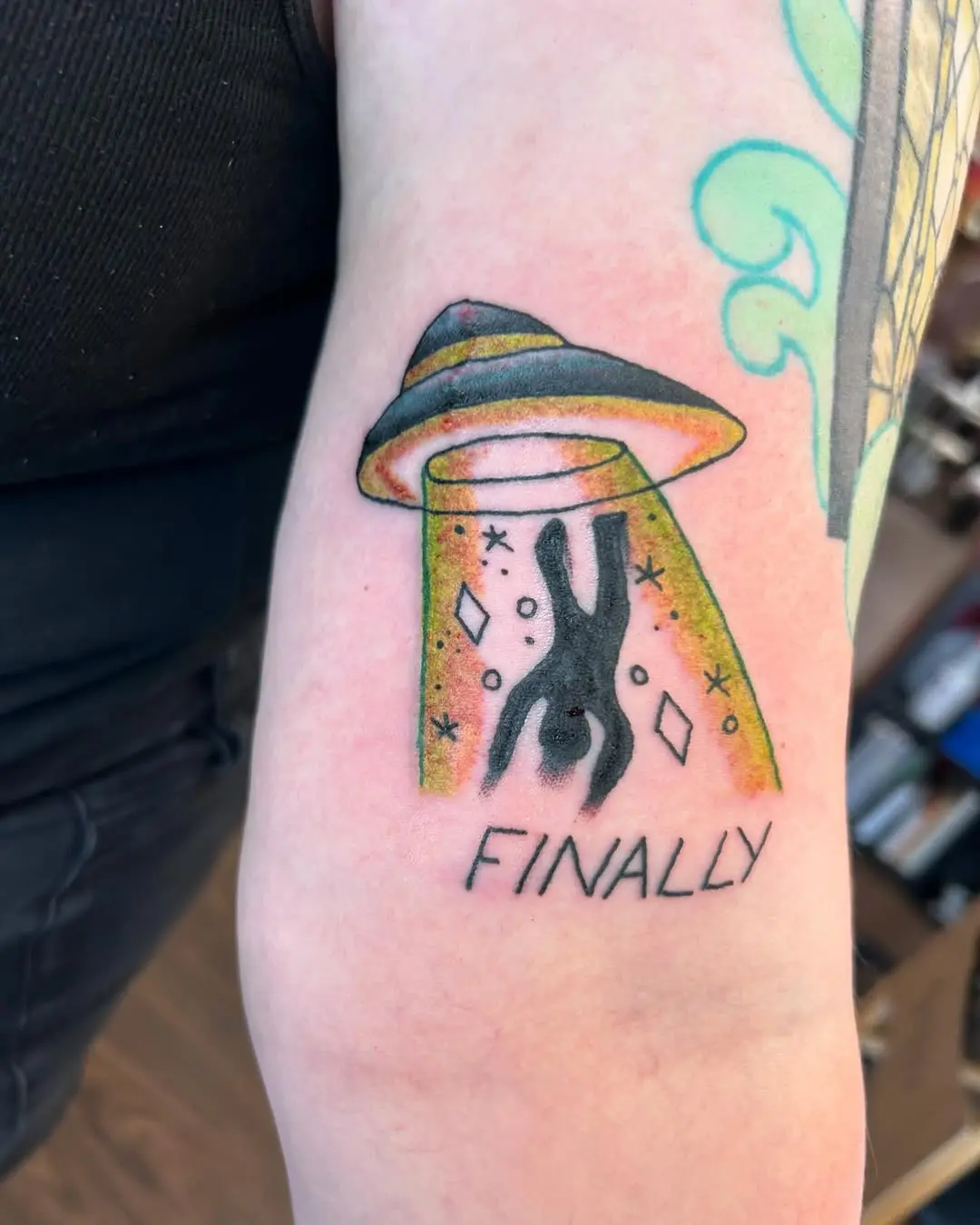 Whimsical UFO Abduction Tattoo with Colorful Details