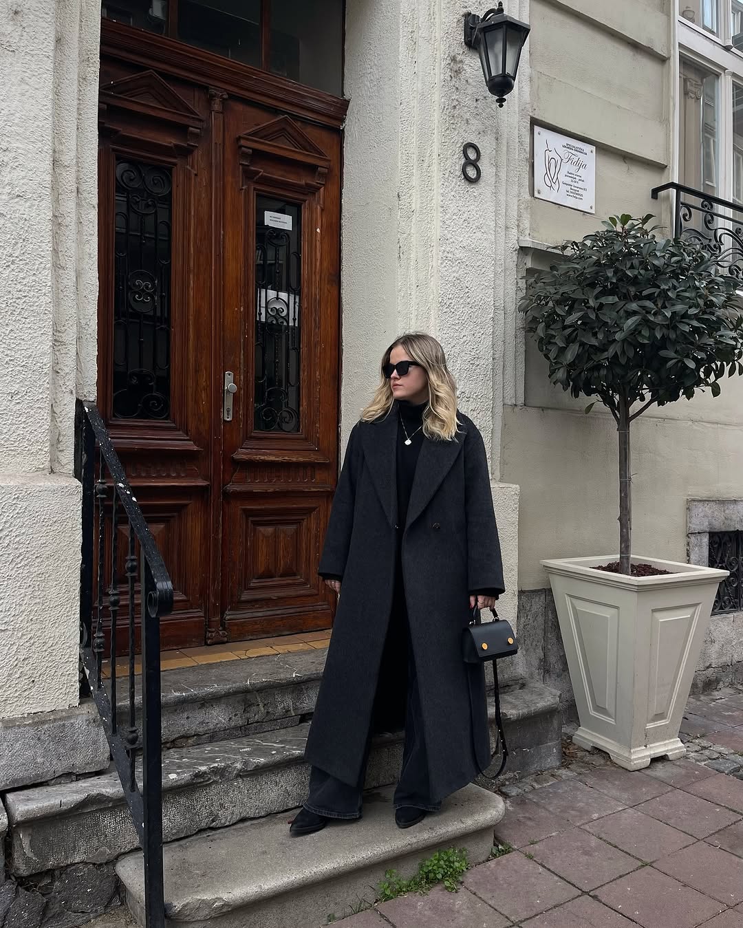 Chic all-black ensemble with a long coat