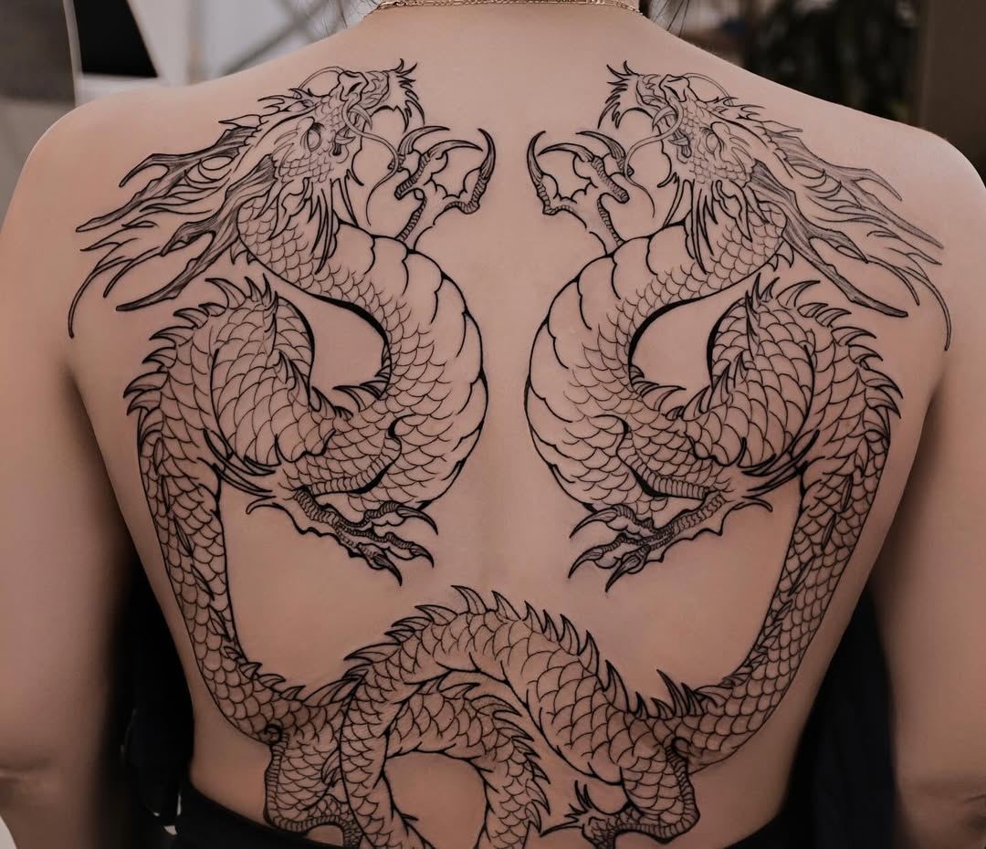 Intricate twin dragons embracing on back