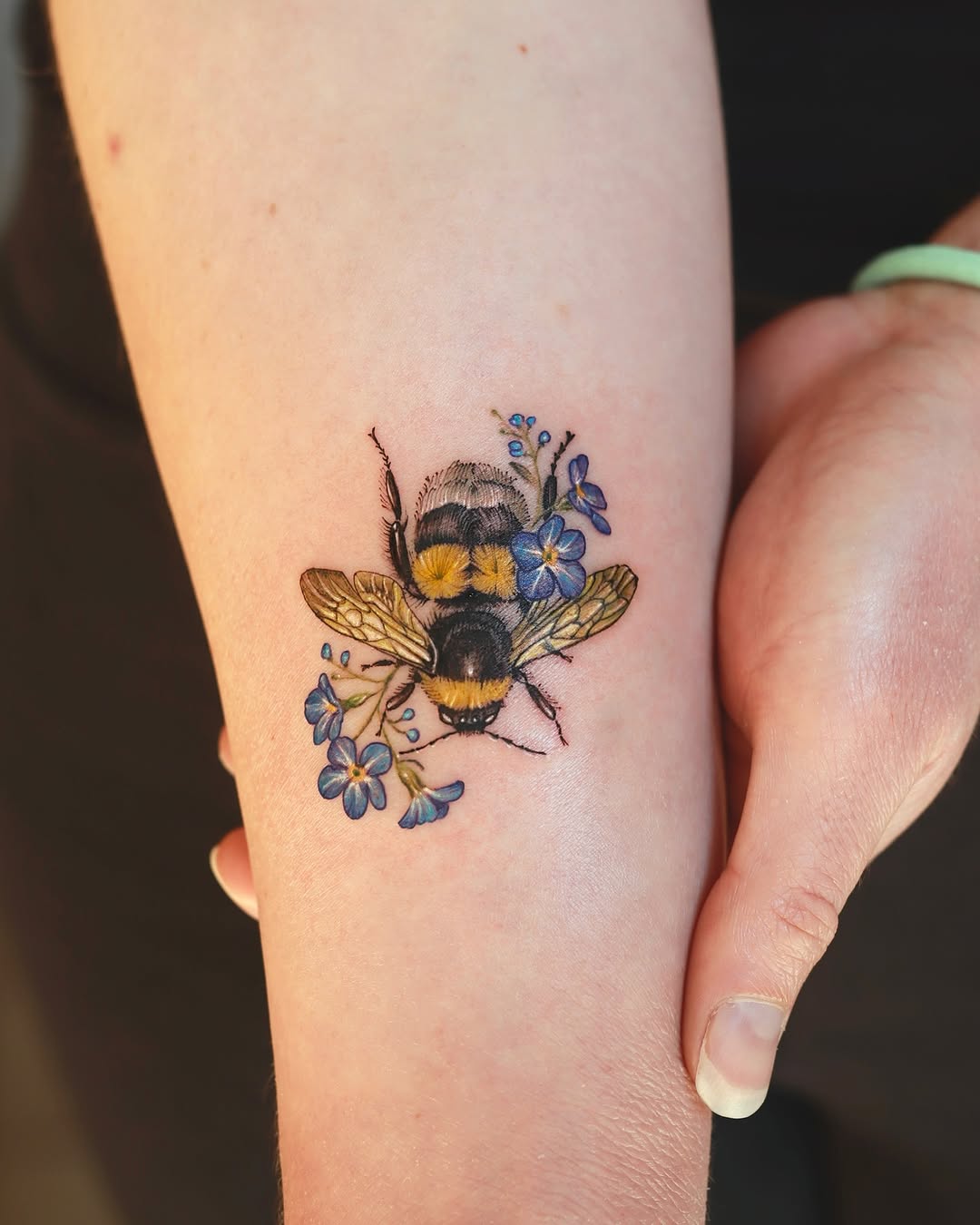 Colorful bumblebee surrounded by delicate flowers