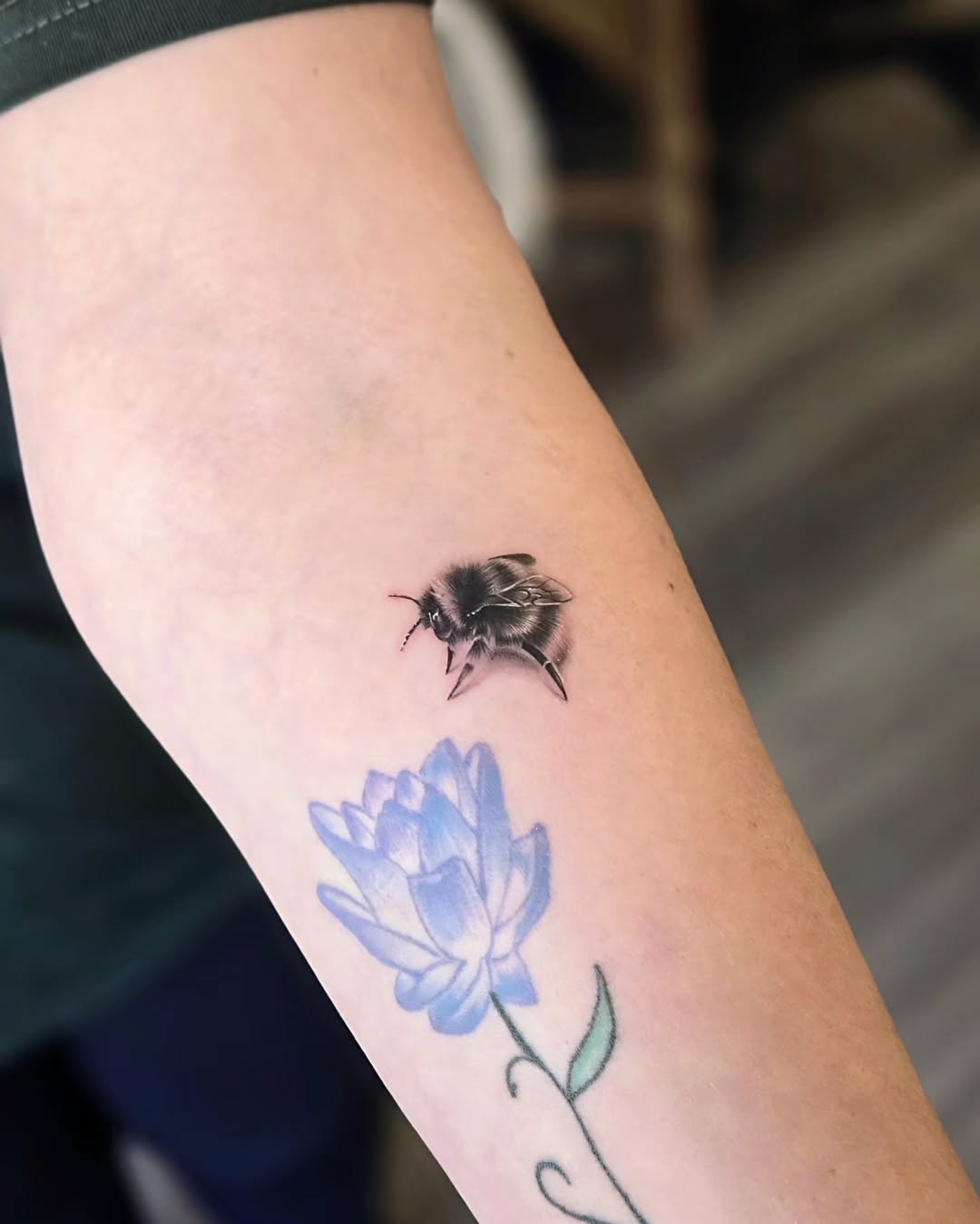 Stunning realistic bee tattoo with floral design