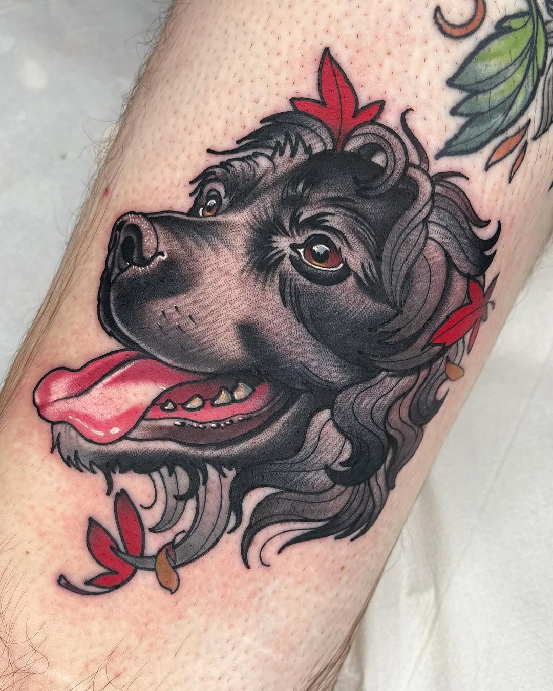 Vibrant Black Dog Tattoo Featuring Leaves