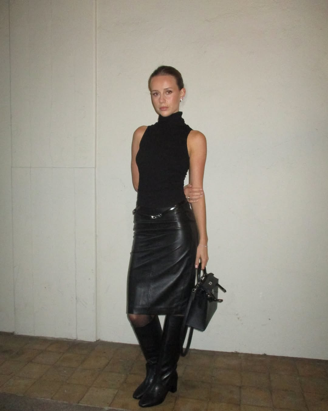 Chic black leather skirt with stylish turtleneck