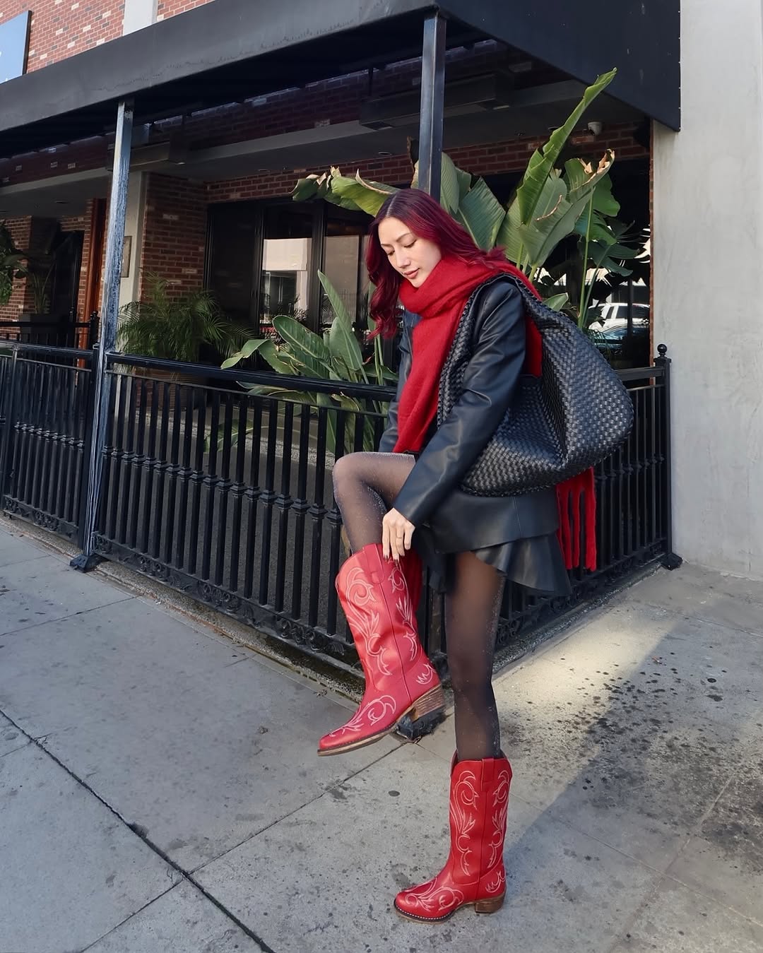 Chic red boots elevate casual street style.