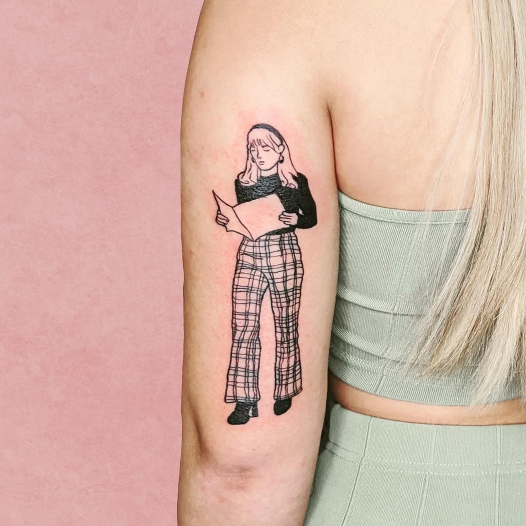 Stylish tattoo of a reading woman