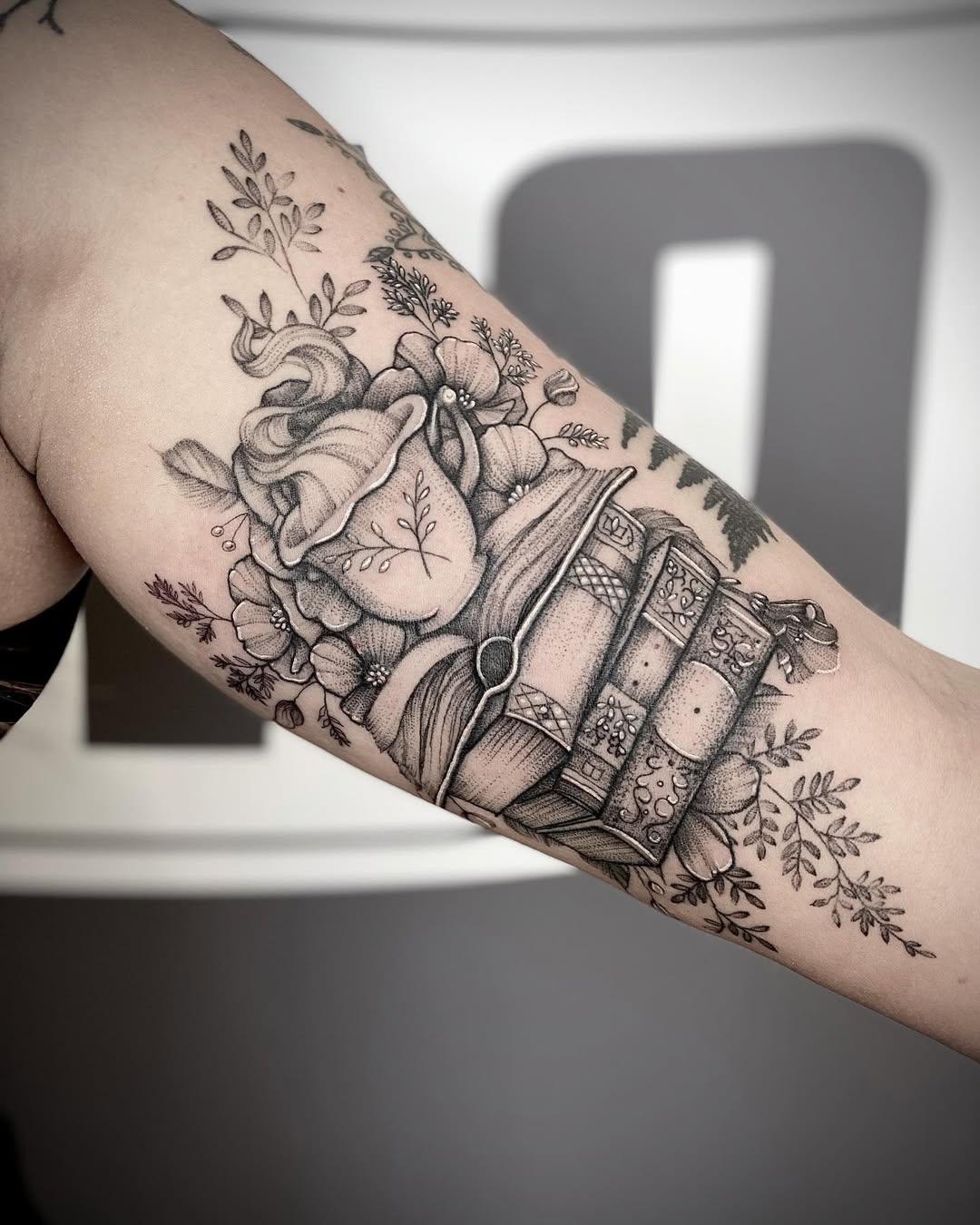 Elegant Book Tattoo with Floral Accents