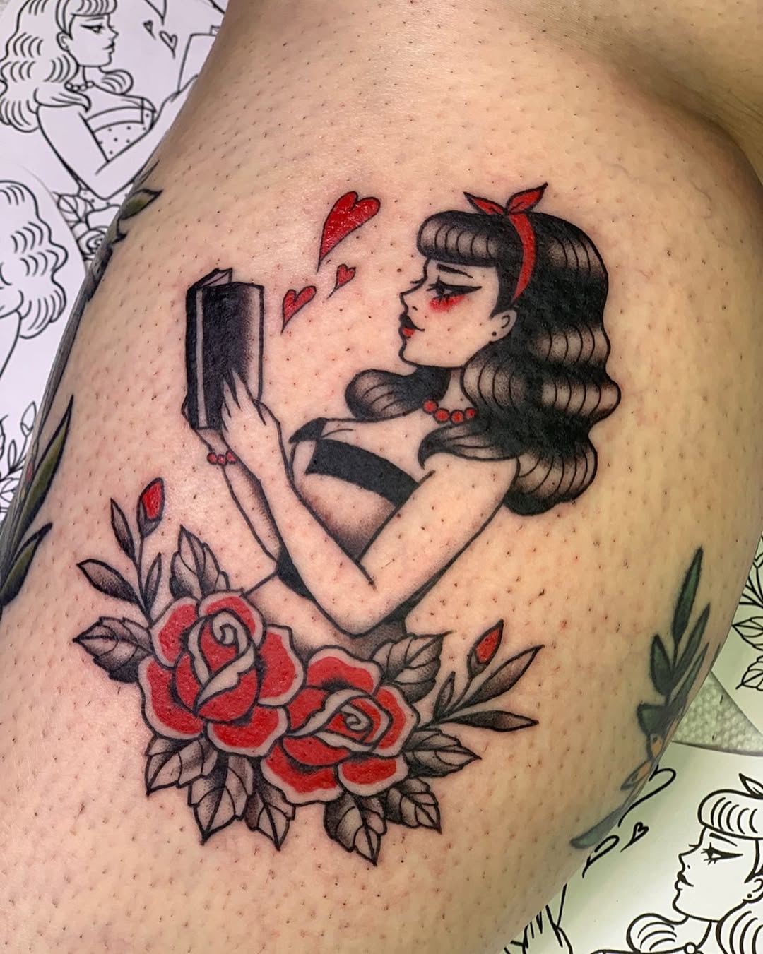 Elegant tattoo of a reading girl with roses