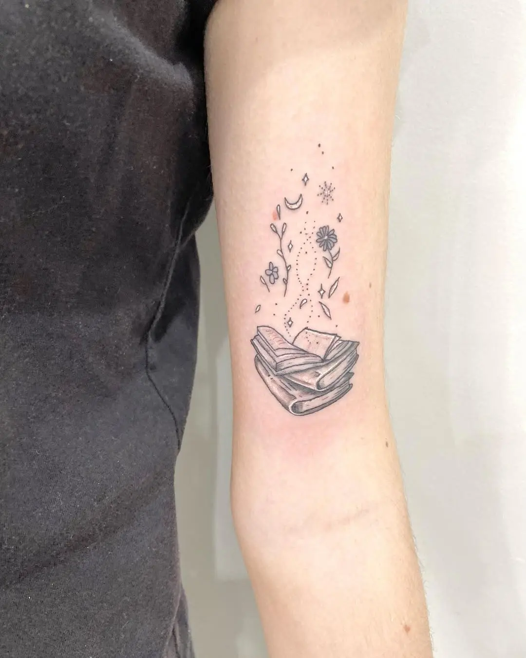 Delicate Book Tattoo with Floral Elements