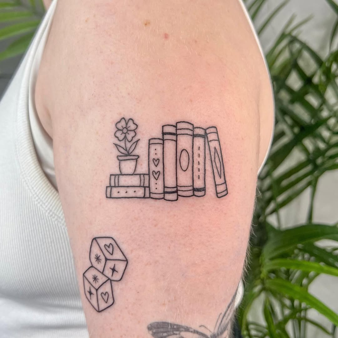 Charming book tattoo with floral accents