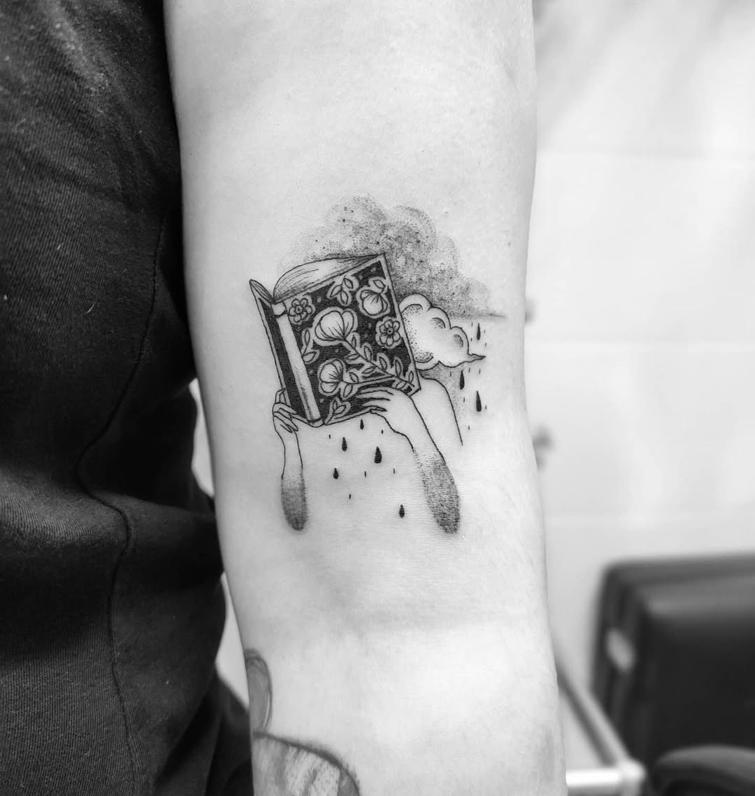 Intricate book tattoo with whimsical elements