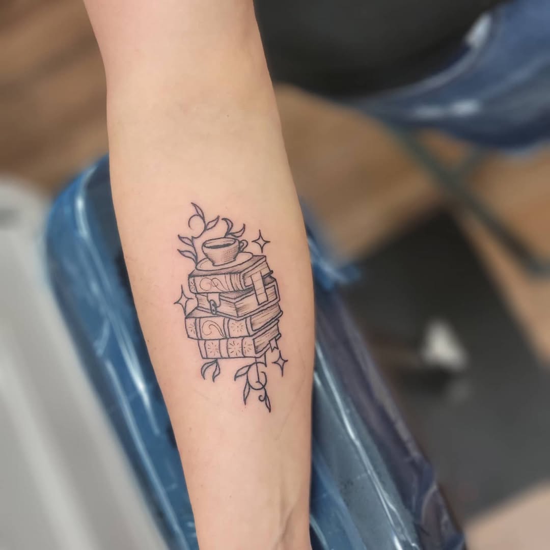 Charming tattoo of stacked books and a teacup